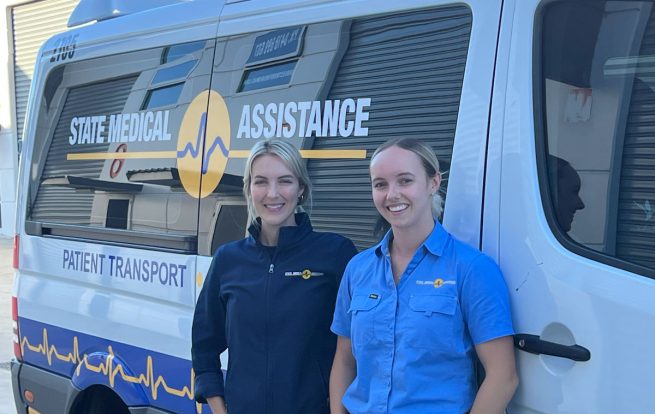 Paramedics in front of patient transport vehicle